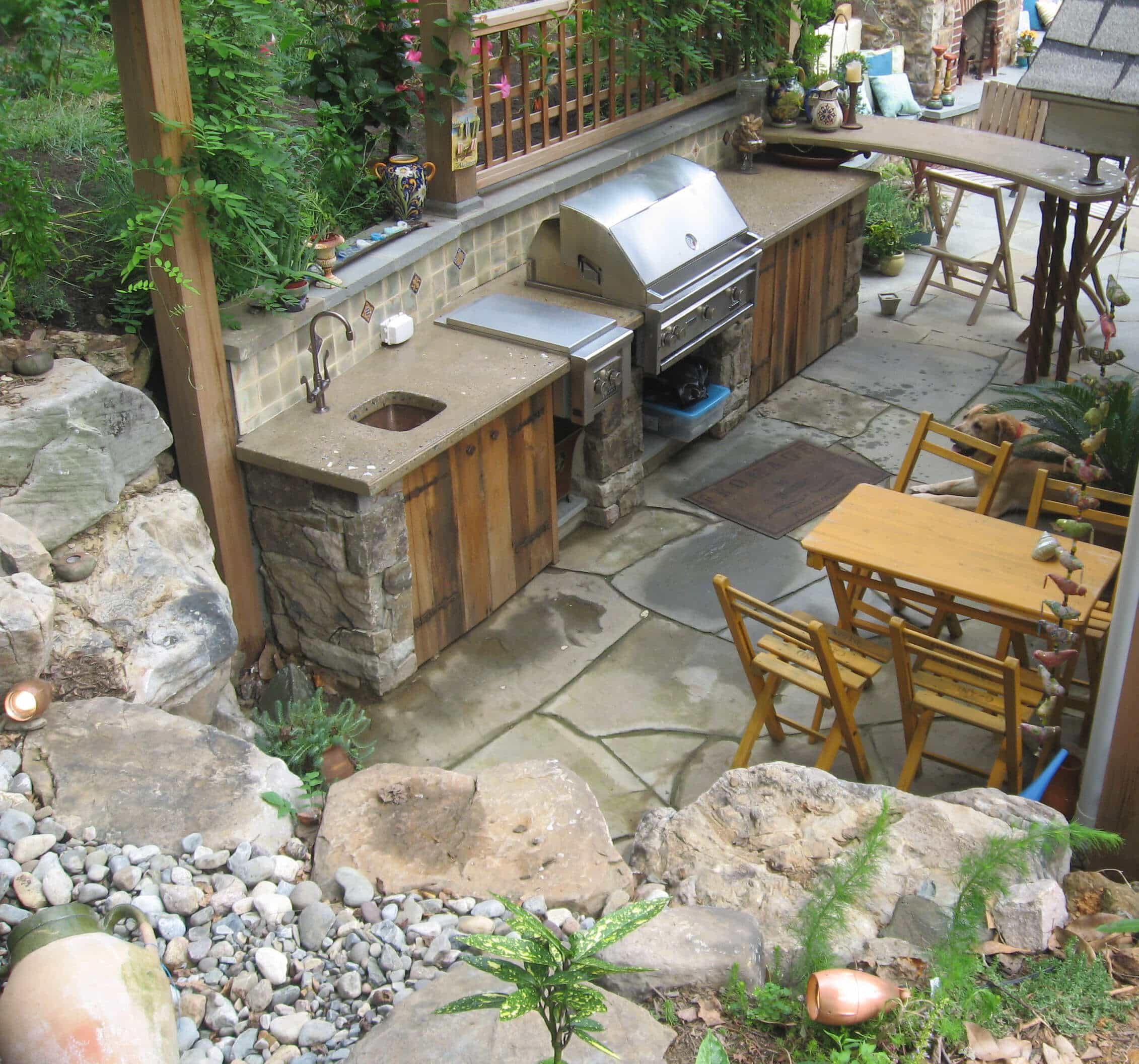 17 Outdoor Kitchen with Concrete Countertop, Stone Walls and Retaining Boulders