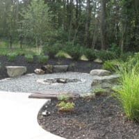 252 Low-Profile Wood-Burning Firepit with Boulder Seating and Gravel Surround