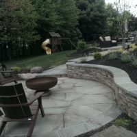 339 Stone Retaining Wall with Flagstone Cap Provides Patio with Extra Seating