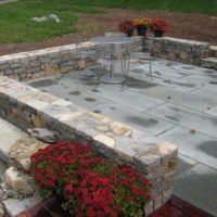 61 Stone Retaining and Sitting Walls Surround a Flagstone Patio