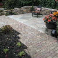 Brick Walkway Leads to Flagstone Patio and Stone Garden Garden Wall