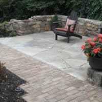 Flagstone Patio with Relic Stone Wall and Brick Walkway