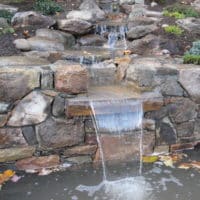 Hillside Waterfall with Cantilevered Stone Wall