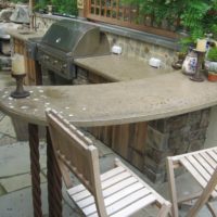 16 Outdoor Kitchen Area with Concrete Countertop, Stone Walls and Retaining Boulders with Urn Water Feature