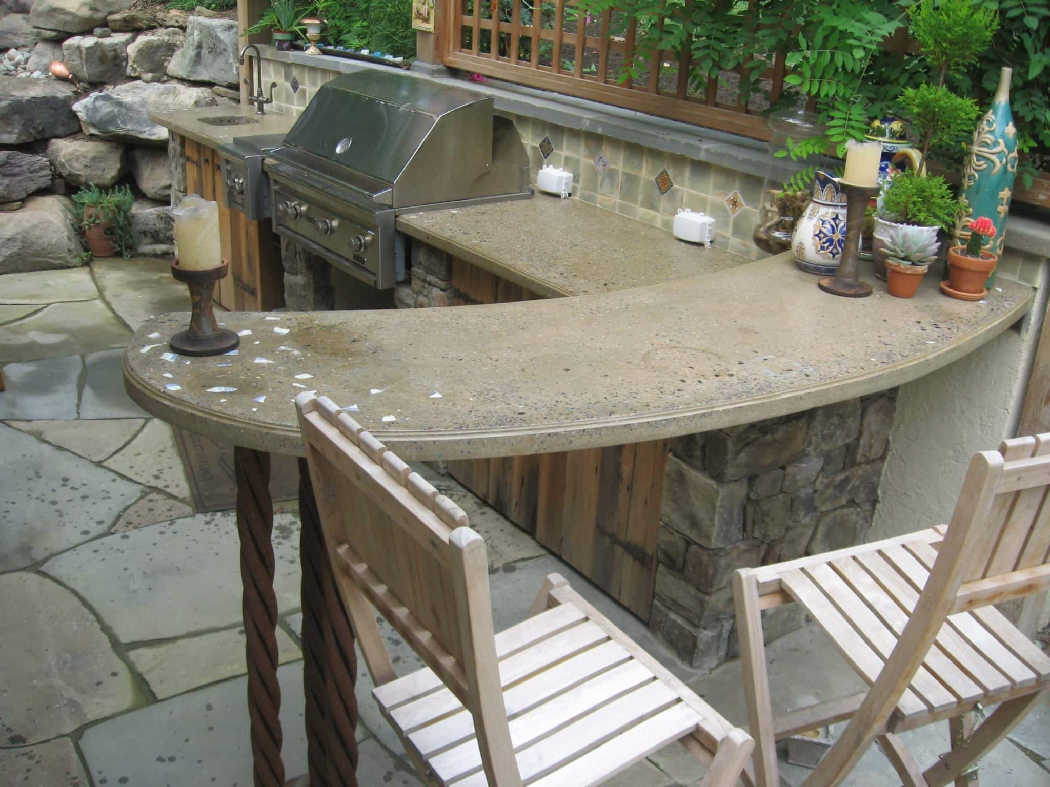 16 Outdoor Kitchen Area with Concrete Countertop, Stone Walls and Retaining Boulders with Urn Water Feature