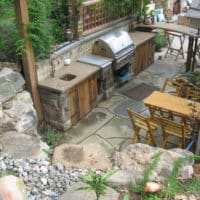17 Outdoor Kitchen with Concrete Countertop, Stone Walls and Retaining Boulders