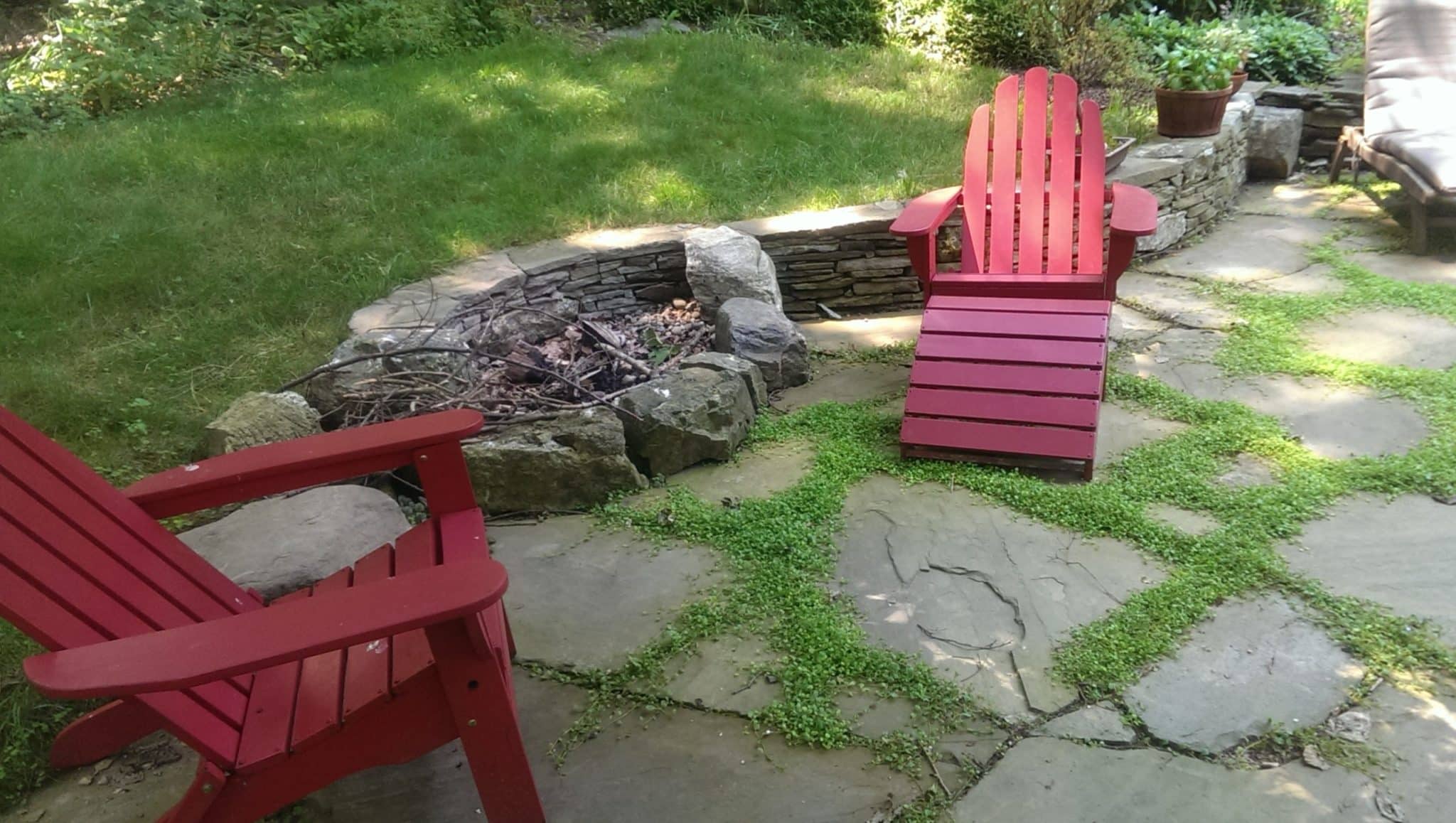 Loosely Laid Flagstone Patio with Stone Retaining Wall and Firepit