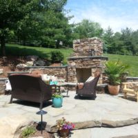 232 Flagstone Patio Built Into Hillside with Stone Fireplace and Terraced Stone Retaining Walls with Caps