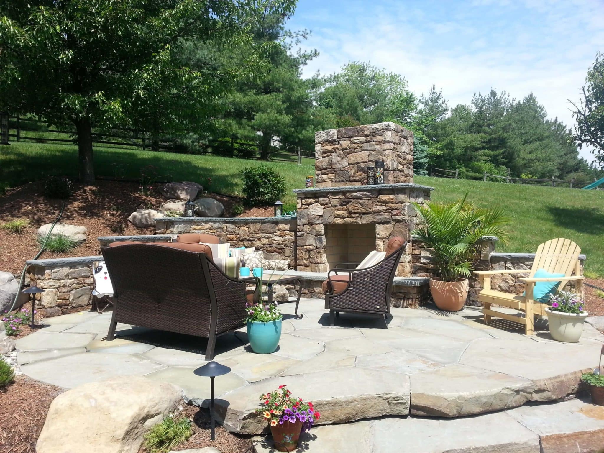 232 Flagstone Patio Built Into Hillside with Stone Fireplace and Terraced Stone Retaining Walls with Caps