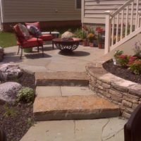 382 Flagstone Patio Off Deck with Boulders, Stone Retaining Wall and Stone Steppers