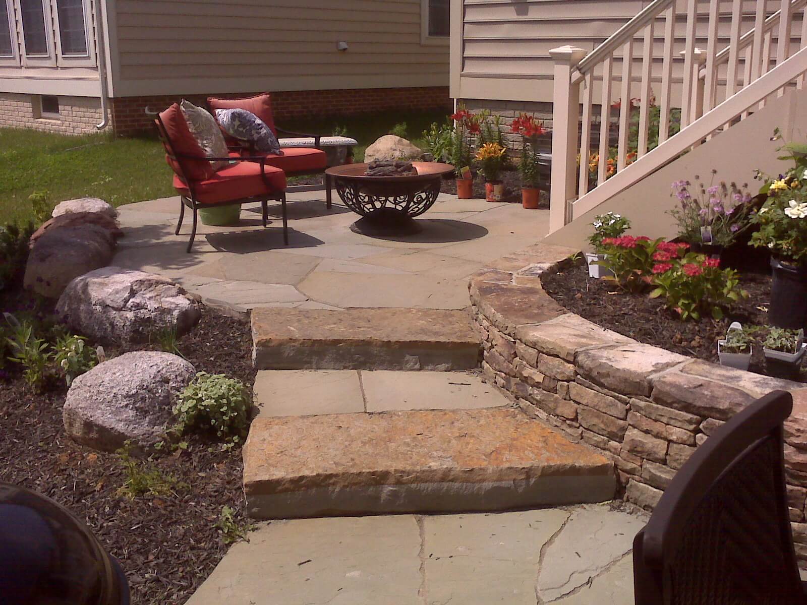 382 Flagstone Patio Off Deck with Boulders, Stone Retaining Wall and Stone Steppers