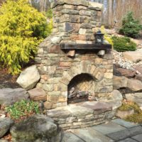 432 Stone Fireplace with Raised Stone Hearth Set Into Hillside