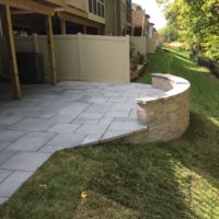 562 Townhouse Patio in Techo-Bloc Aberdeen Azzurro Pavers with Curved Sitting Wall & Retaining Wall