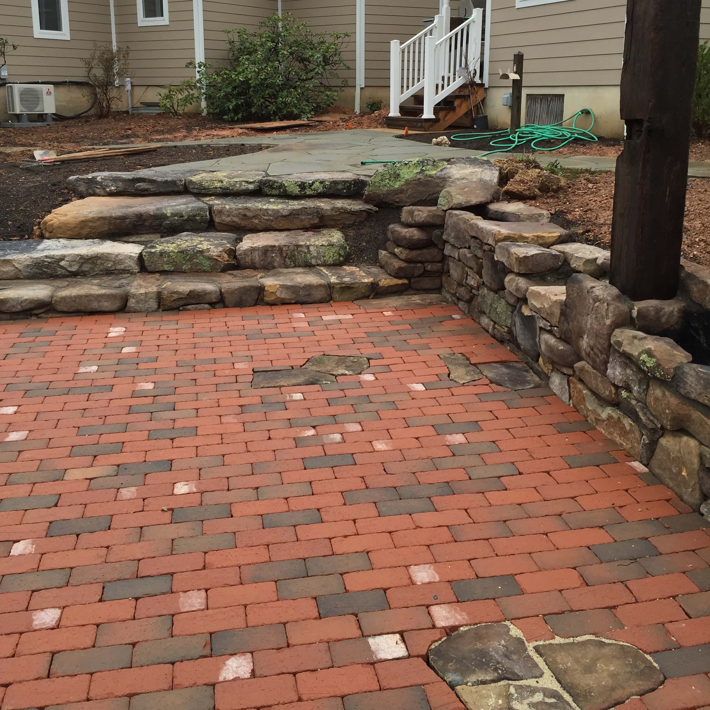574 Rustic Brick Patio with Stone Inlay and Rustic Stone Walls