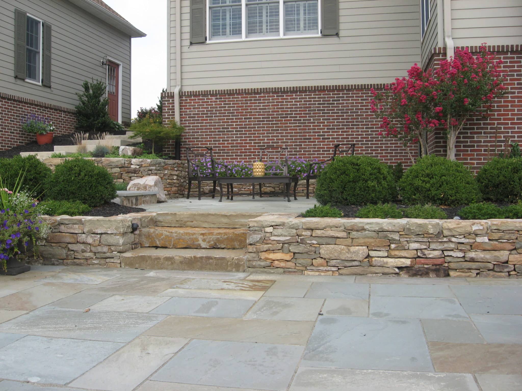 Formal Flagstone Patio with Stone Walls, Built In Grill, Boulders and Potager Garden 5