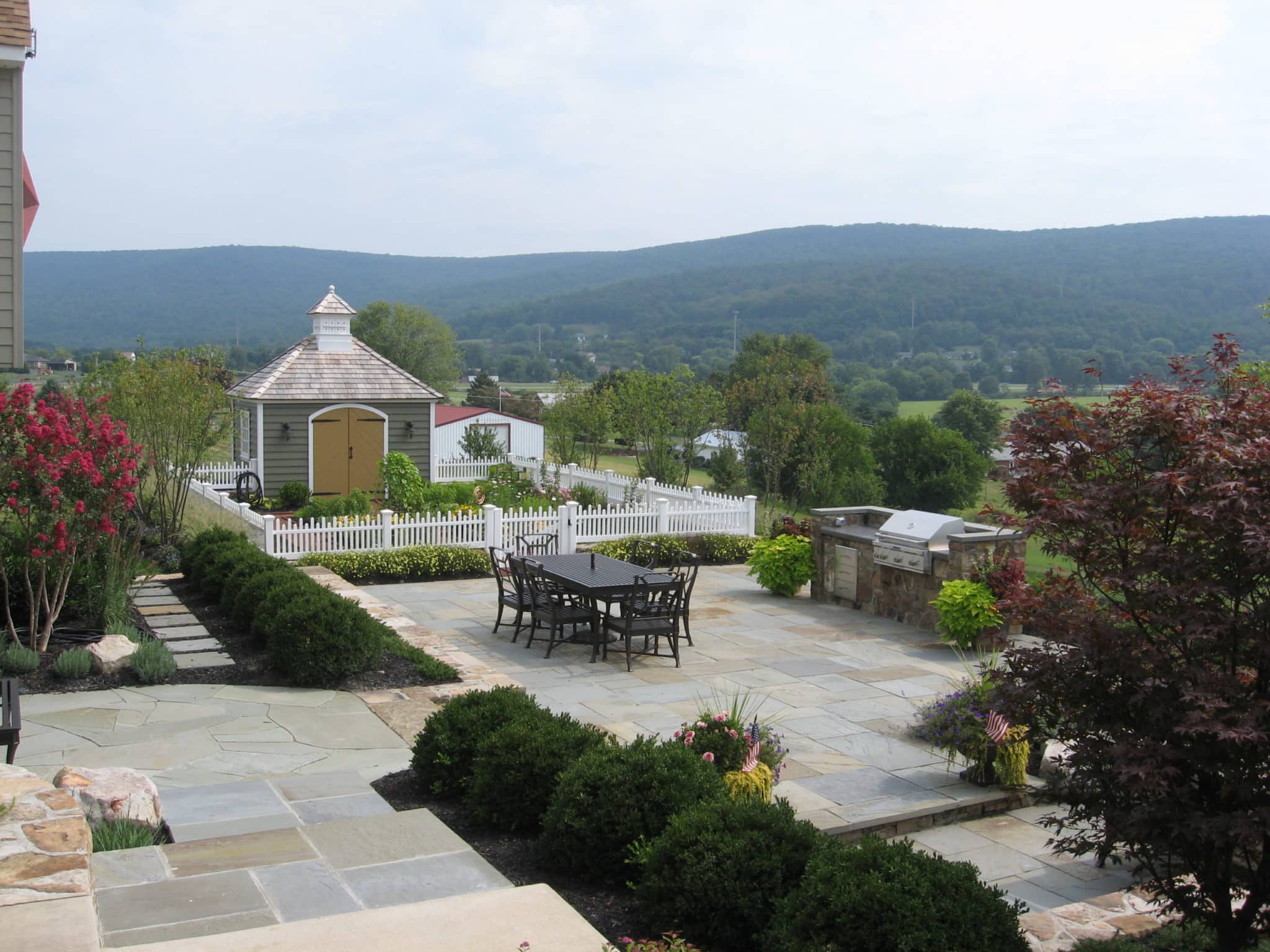 Formal Flagstone Patio with Stone Walls, Built In Grill, Boulders and Potager Garden 3