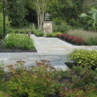 Elegant Front Walkway with Stone Column and Pathlights