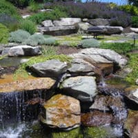 Planted Hillside with Waterfall and Sitting Boulders