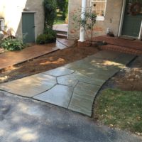 Large Irregular Flagstones Lead to Side Door with Brick Landing