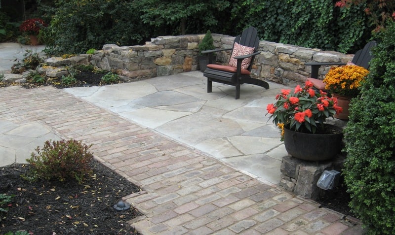 Flagstone Patio with Relic Stone Wall and Brick Walkway